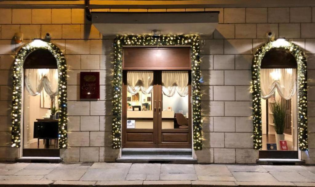 a store front with christmas lights and a door at Loger Confort Residence & Apartments in Turin