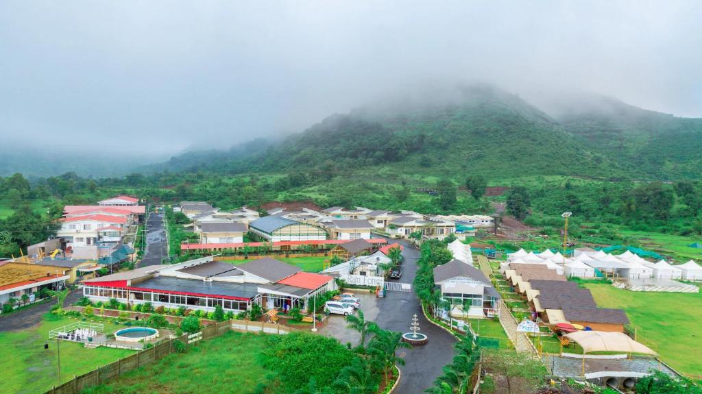 an aerial view of a village with a mountain at Rainforest Resort and Spa, Igatpuri in Igatpuri