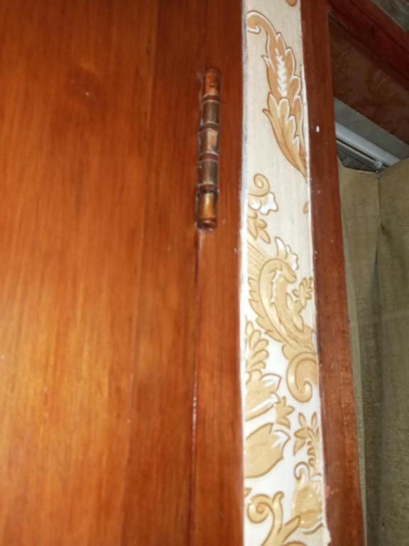 a wooden door with a metal door handle at Mayestik Guest House Syariah in Jakarta
