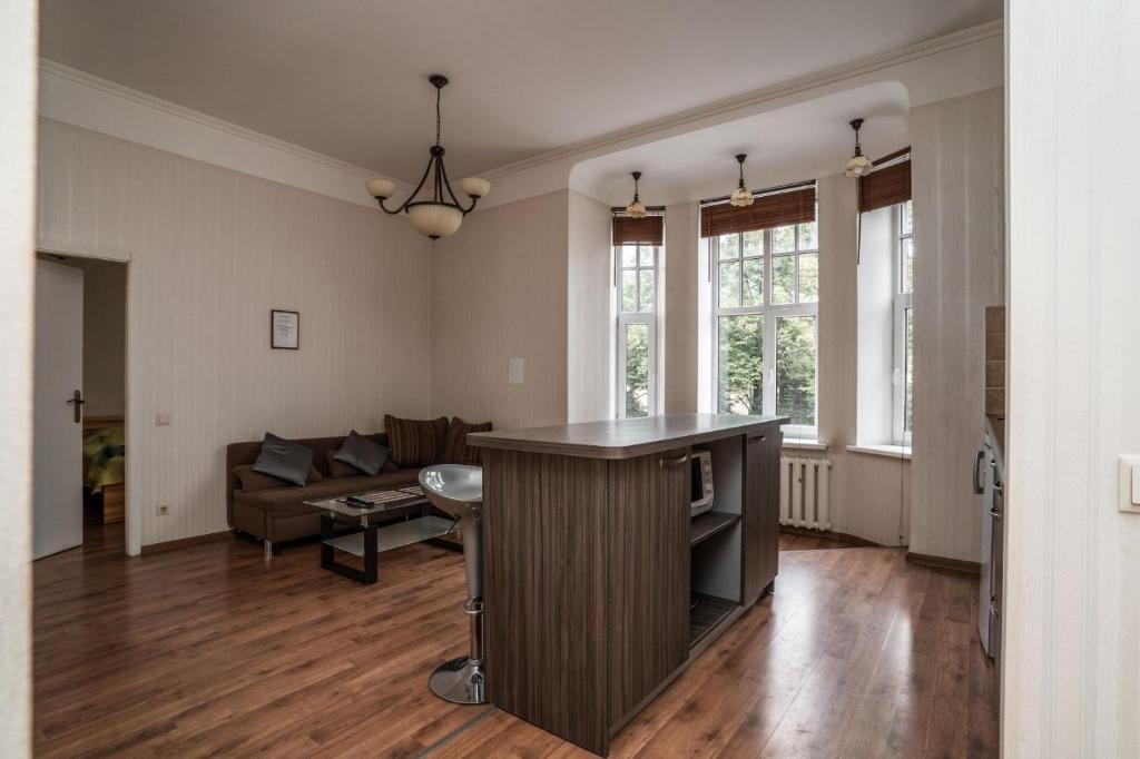 an empty living room with a couch and a table at Lāčplēša Central Apartments in Riga