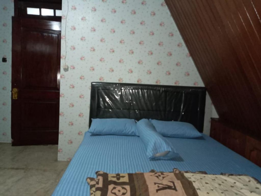 Postel nebo postele na pokoji v ubytování Mayestik Guest House Syariah