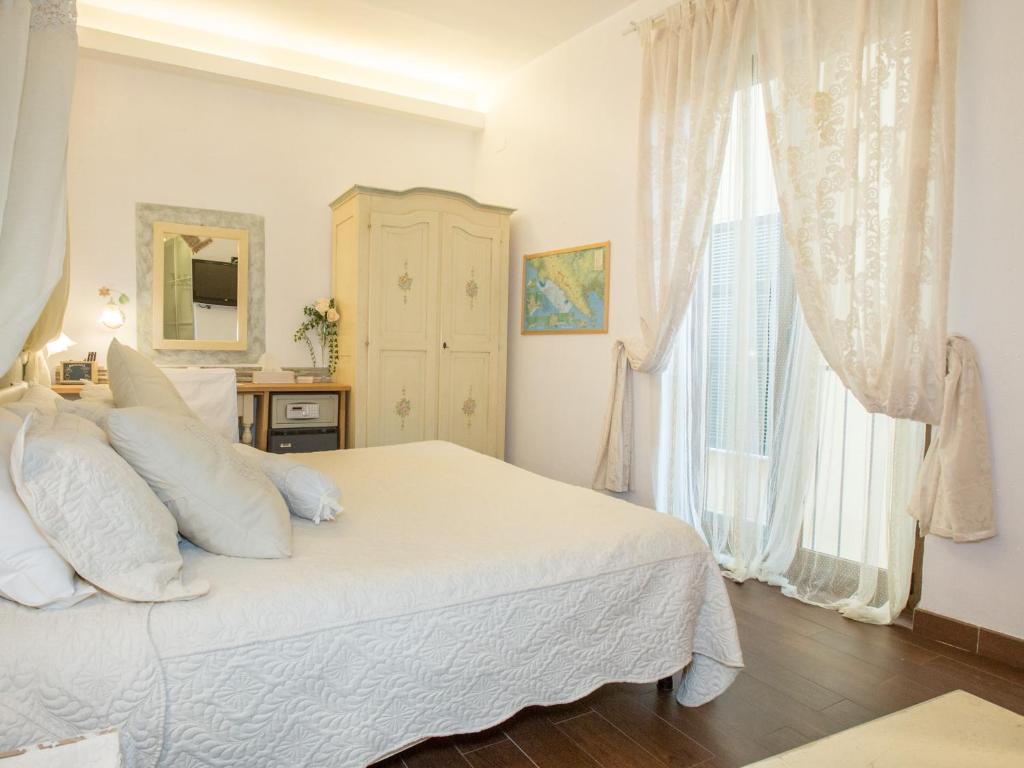 a bedroom with a white bed and a window at Hotel Marina in Monterosso al Mare