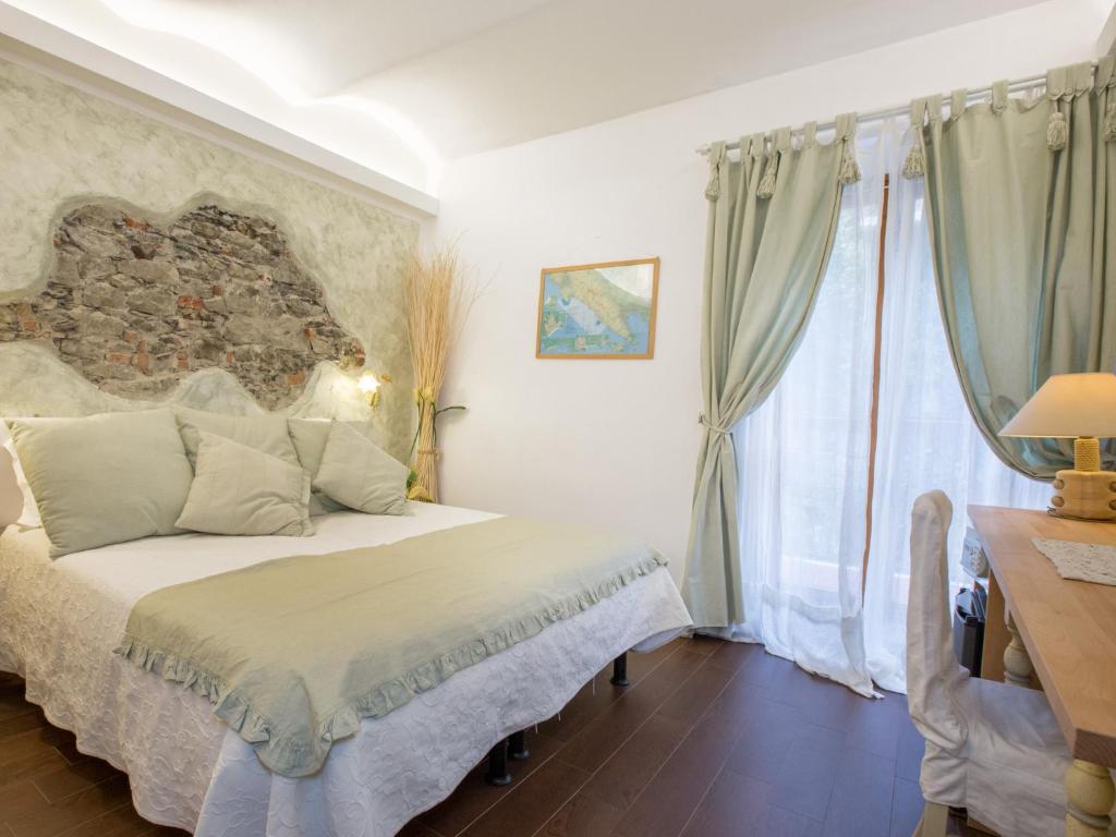 a bedroom with a large bed and a window at Hotel Marina in Monterosso al Mare