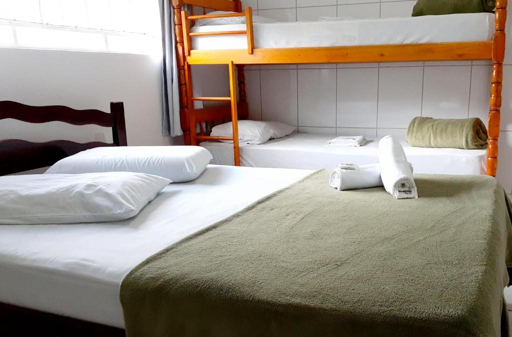 A bed or beds in a room at Hotel Bella Júlia