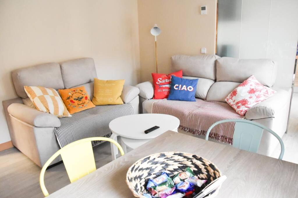 a living room with a couch and a table at Dúplex Casa Lis-En pleno corazón de la ciudad- in Salamanca