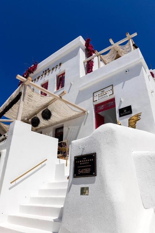 a white building with stairs in front of it at The TownHouse Mykonos in Mýkonos City