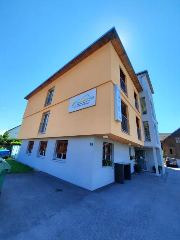 a building with a sign on the side of it at Das smarte Hotel garni in Höchst