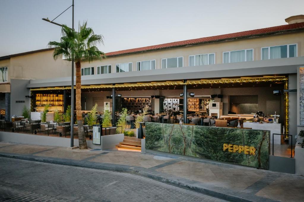 a building with a library with tables and chairs at Napa Plaza Hotel (Adults Only) in Ayia Napa