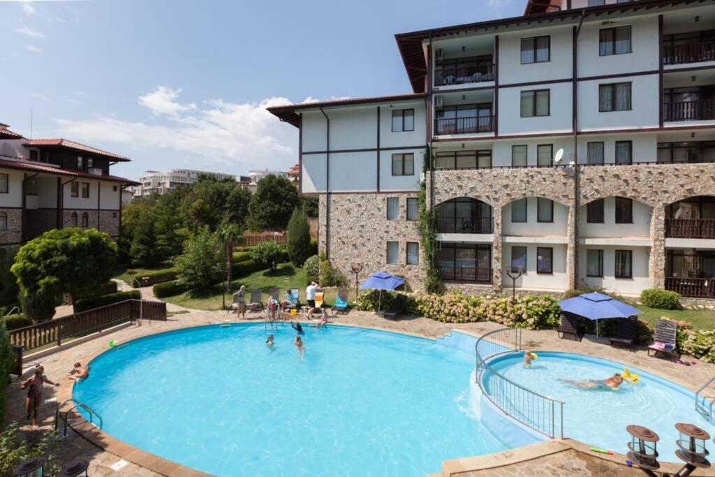 a large swimming pool in front of a building at Etara 2 - Homely 1 Bed Apartment in Sveti Vlas