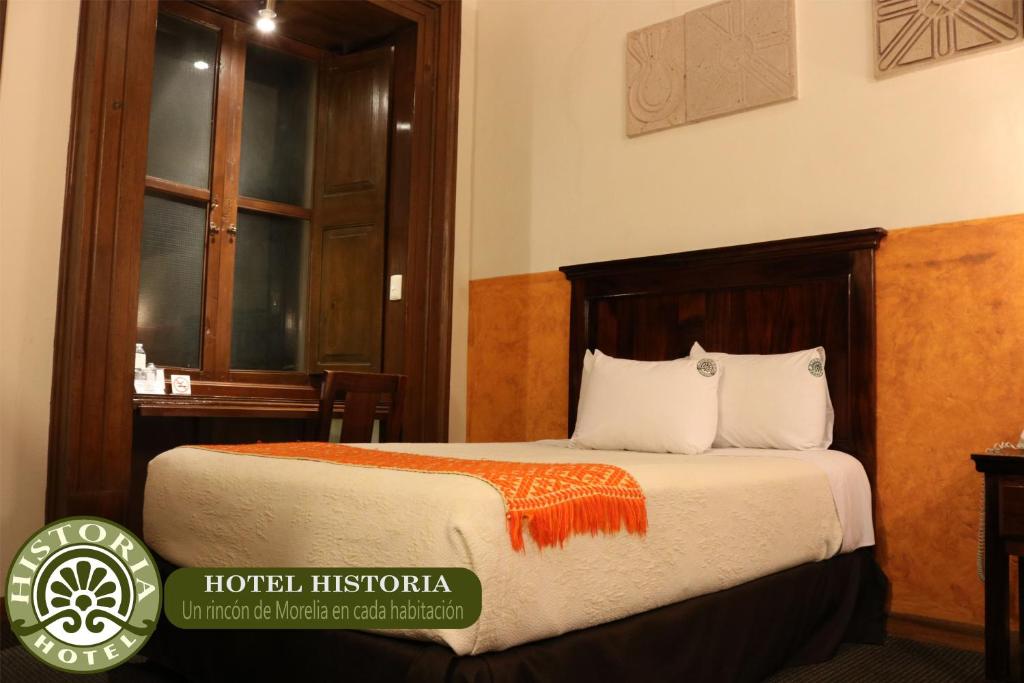 Postel nebo postele na pokoji v ubytování Hotel Historia