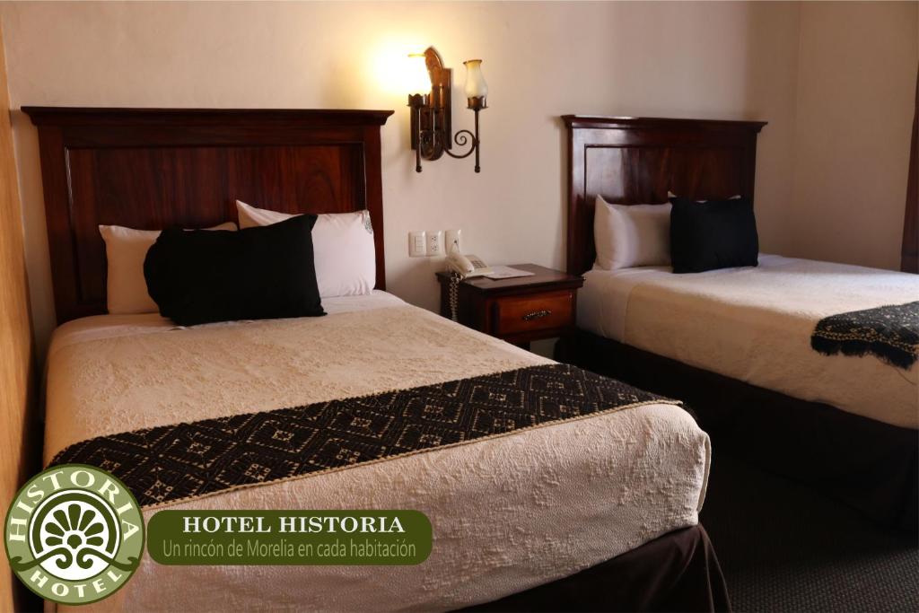 Postel nebo postele na pokoji v ubytování Hotel Historia