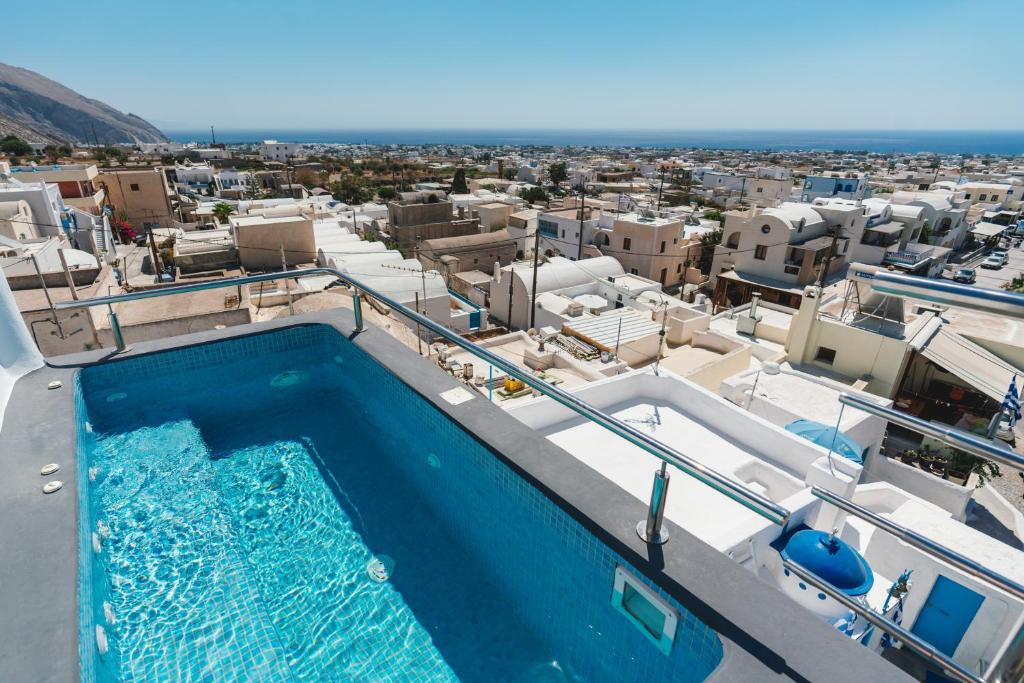 a swimming pool on the roof of a building at Lux house with outdoor jacuzzi and sea view in Santorini in Emporio Santorini