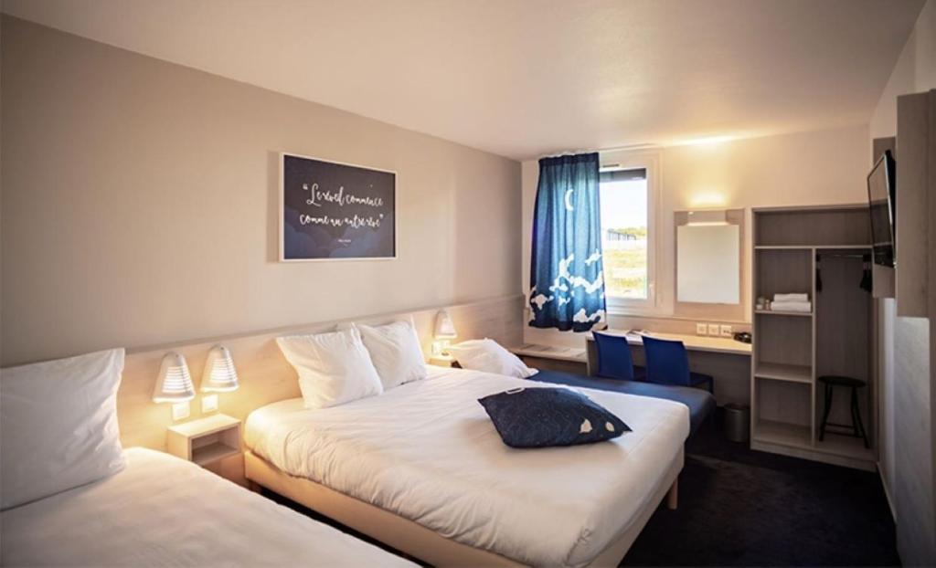 a hotel room with two beds and a window at Ace Hôtel Salon de Provence in Salon-de-Provence