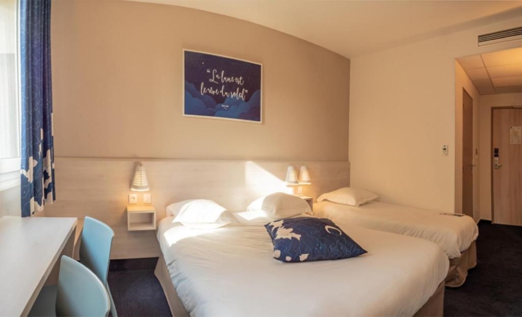 a hotel room with two beds and a picture on the wall at Ace Hôtel Salon de Provence in Salon-de-Provence
