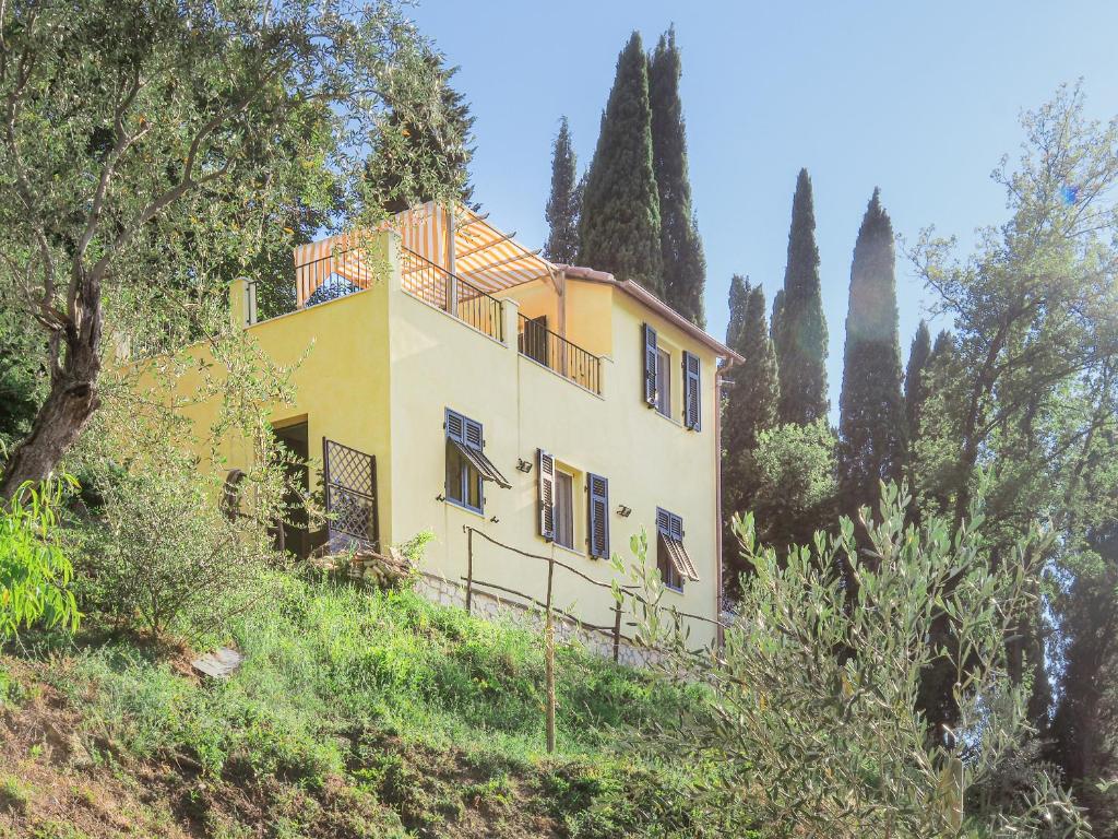 a house on the side of a hill with trees at Venus House in Lerici