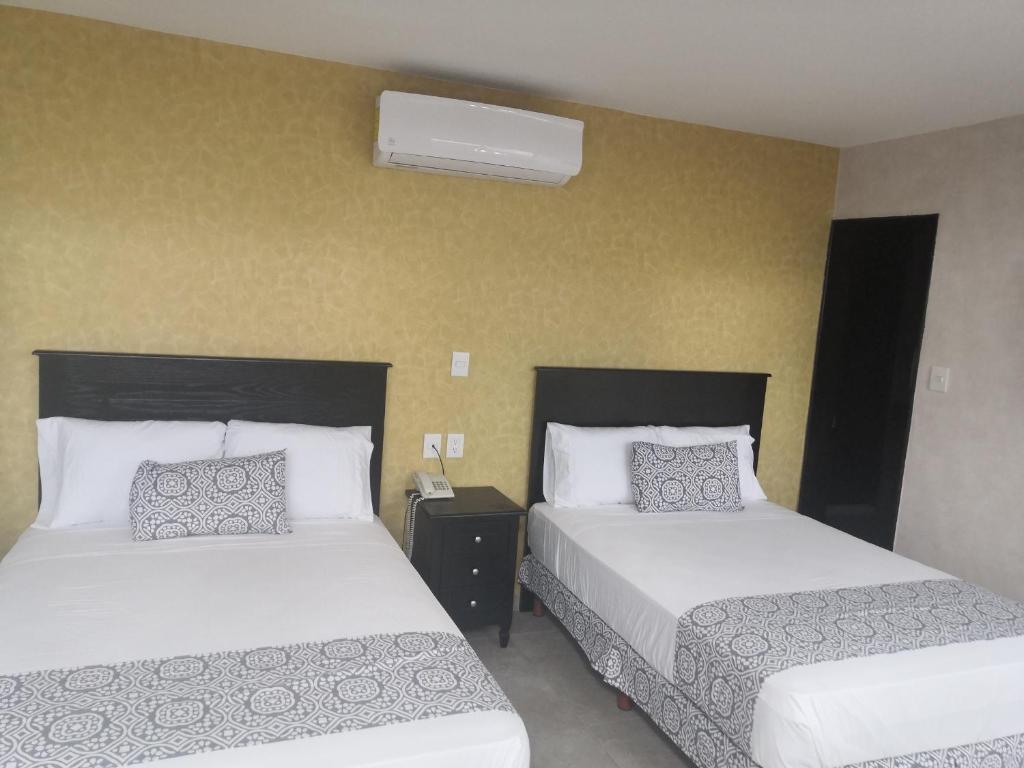 Postel nebo postele na pokoji v ubytování Hotel Costa Verde
