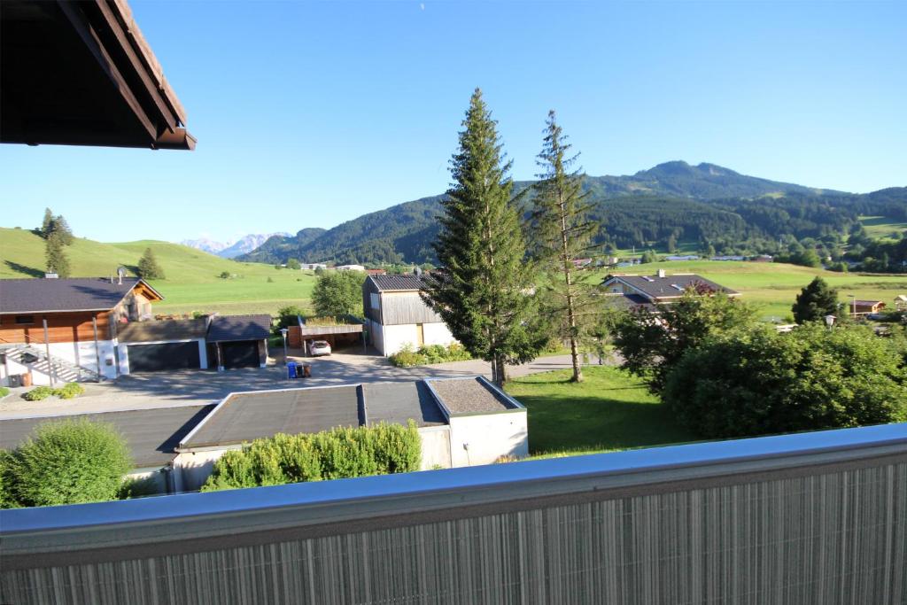 a view from the balcony of a house with a fence at Scheiblesmoos 4 Sterne in Nesselwang