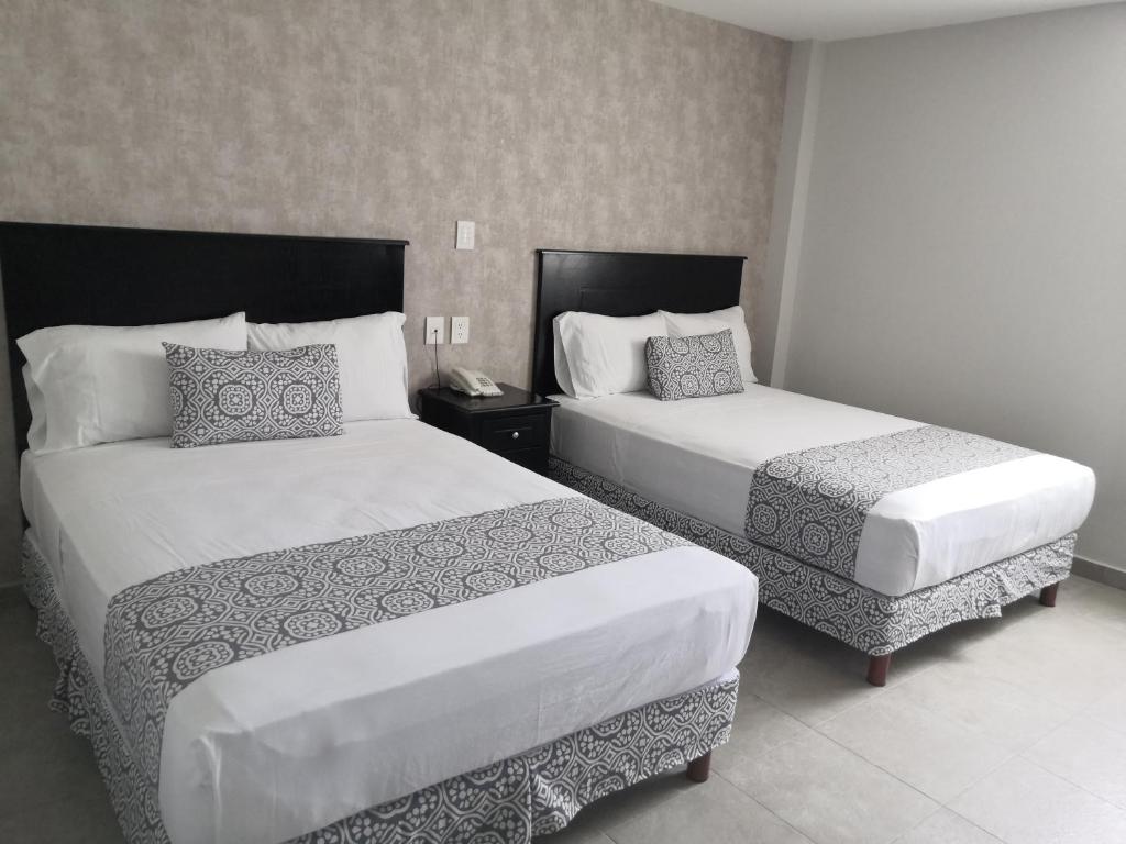 Postel nebo postele na pokoji v ubytování Hotel Costa Verde