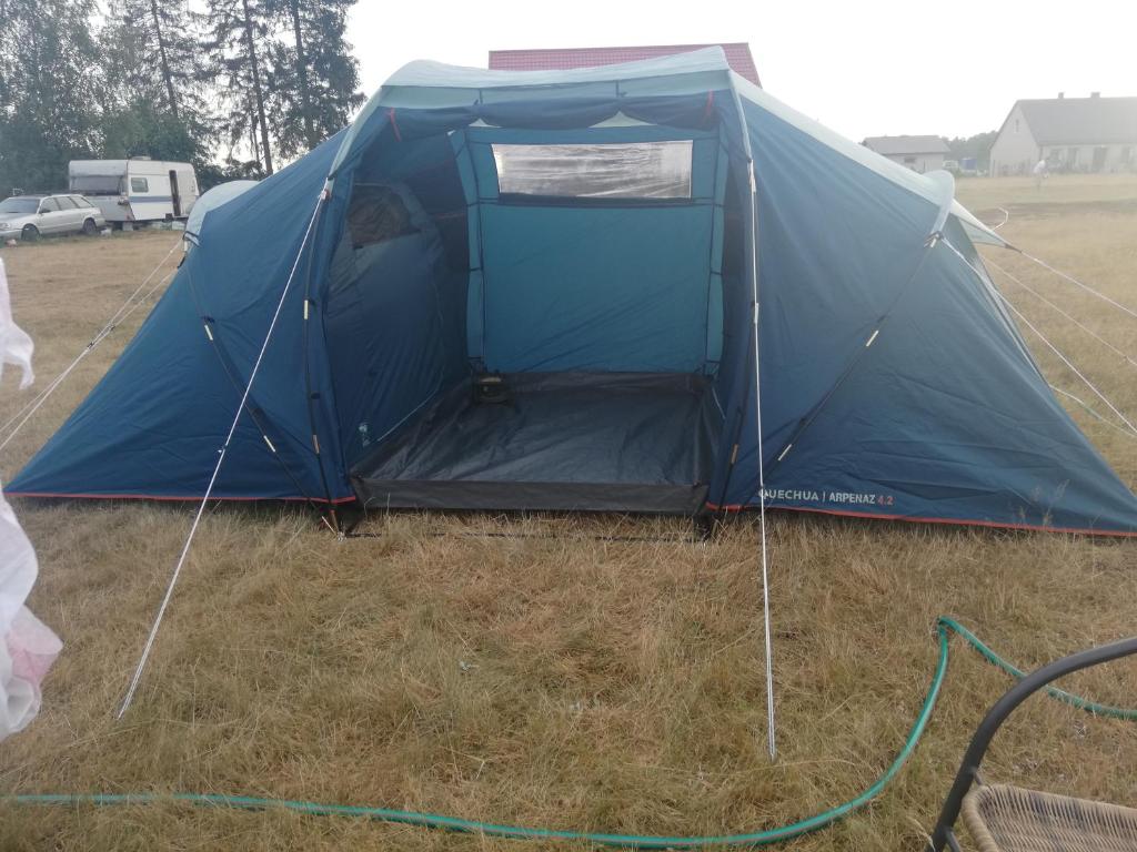 een blauwe tent met de deur open in een veld bij Peace & Quiet in Sławoborze