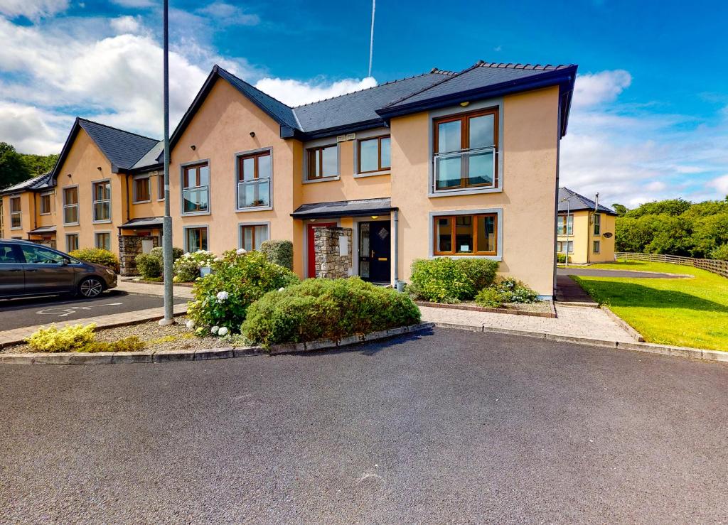 a house with a car parked in front of it at Lakeside Holiday Homes in Killaloe