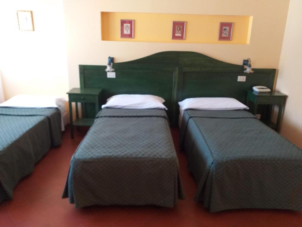 Postel nebo postele na pokoji v ubytování Hotel Monna Lisa