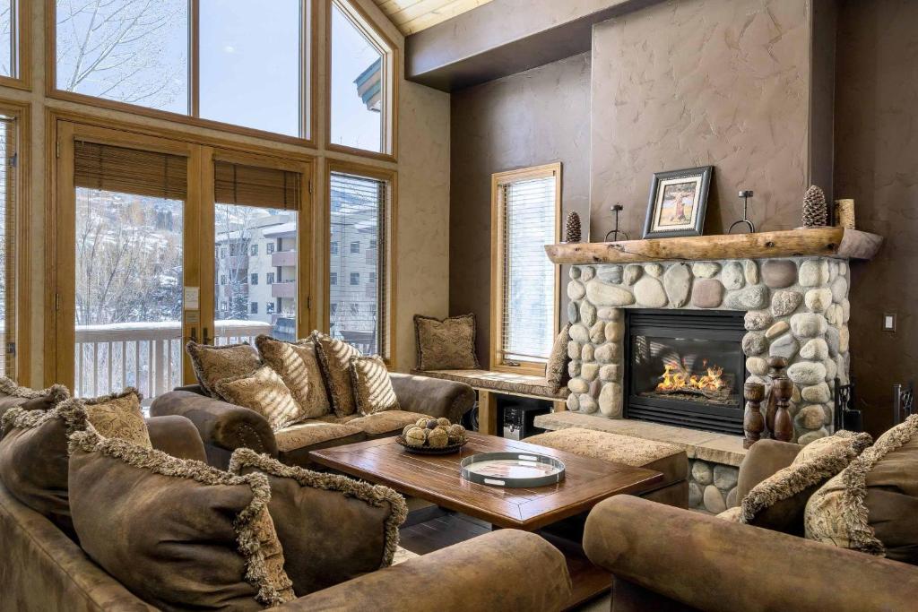 a living room with couches and a fireplace at Evergreens 04 in Steamboat Springs