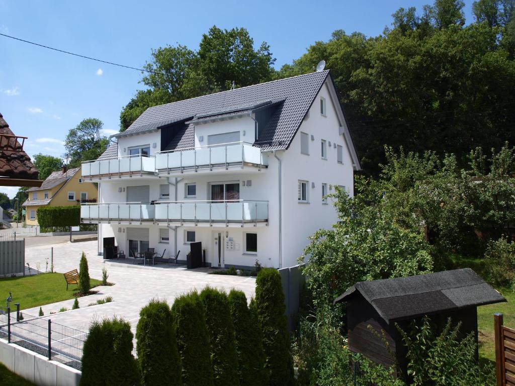 a white house with a lot of balconies at Gästehaus Munk in Günzburg