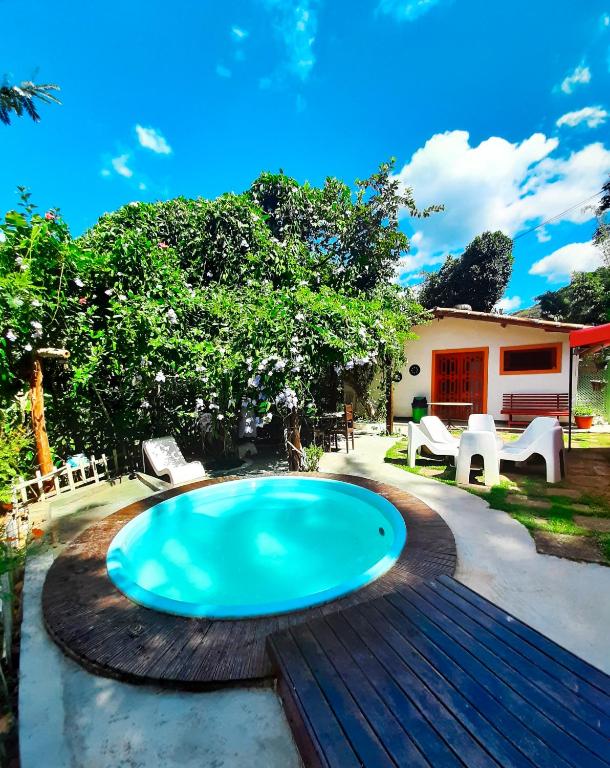 a swimming pool on a deck next to a house at Olho D'Água Pousada in Guaramiranga