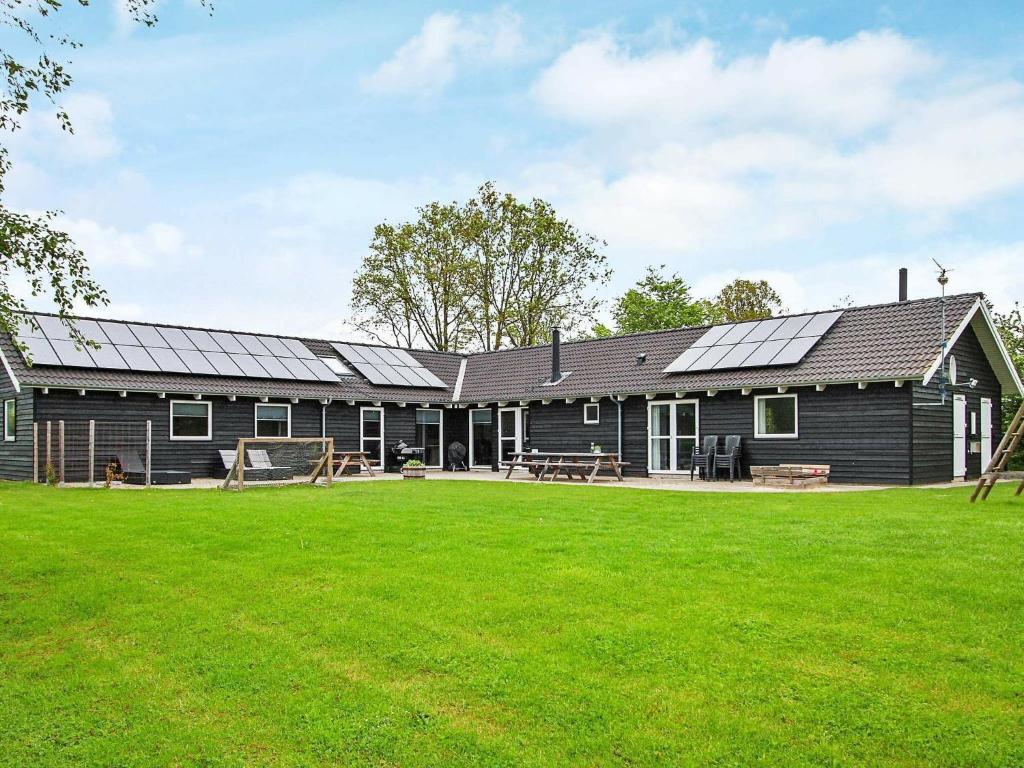 een huis met zonnepanelen aan de zijkant bij 18 person holiday home in Ebeltoft in Ebeltoft