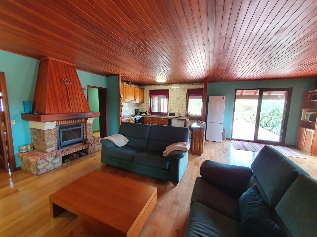 a living room with a couch and a fireplace at Casa de Castro Laboreiro in Castro Laboreiro