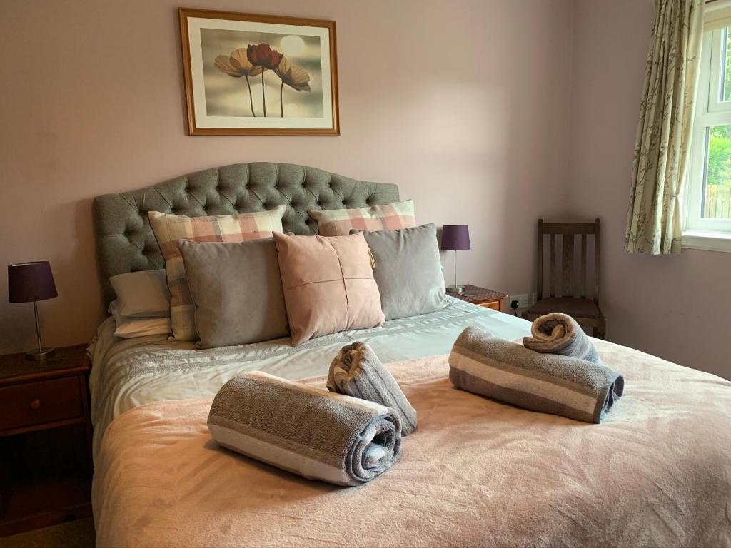 a bedroom with a large bed with towels on it at Brada View Bamburgh in Bamburgh