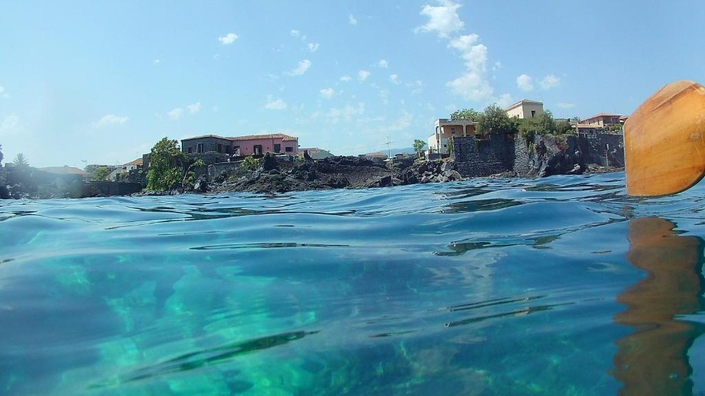 a view of the water with houses in the background at Le case di Carlotta & Giorgia in Pozzillo