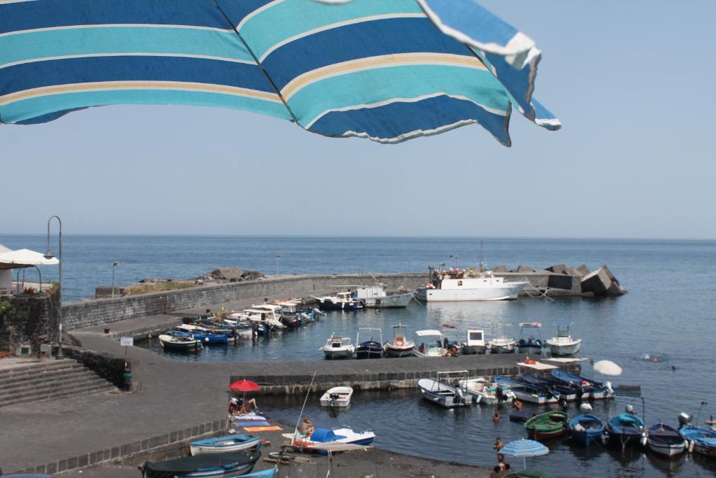 a group of boats in a marina with an umbrella at Le case di Carlotta & Giorgia in Pozzillo