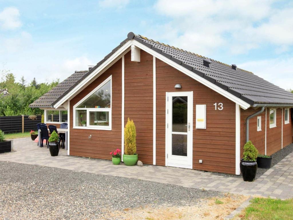 a small house with a pitched roof at Three-Bedroom Holiday home in Hemmet 55 in Hemmet