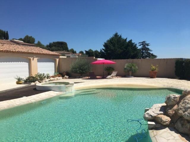 a swimming pool in a yard with a house at Château Gombert in Marseille