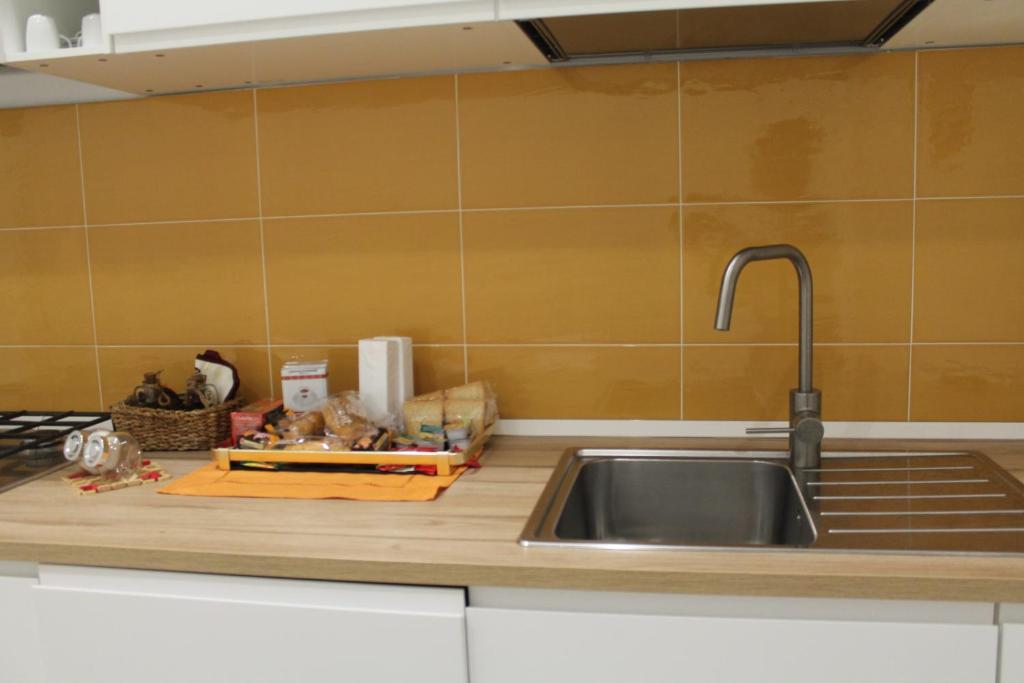 a kitchen counter with a sink and a counter top at Le case di Carlotta & Giorgia in Pozzillo