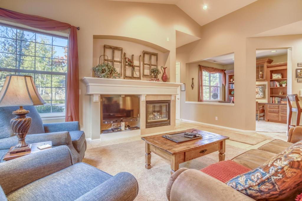 a living room with two couches and a fireplace at Peaceful in the Parks in Bend