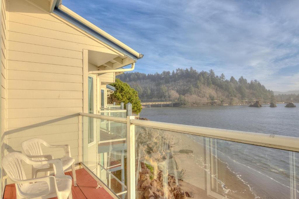 a balcony with chairs and a view of the water at Dock of the Bay 305 in Lincoln City