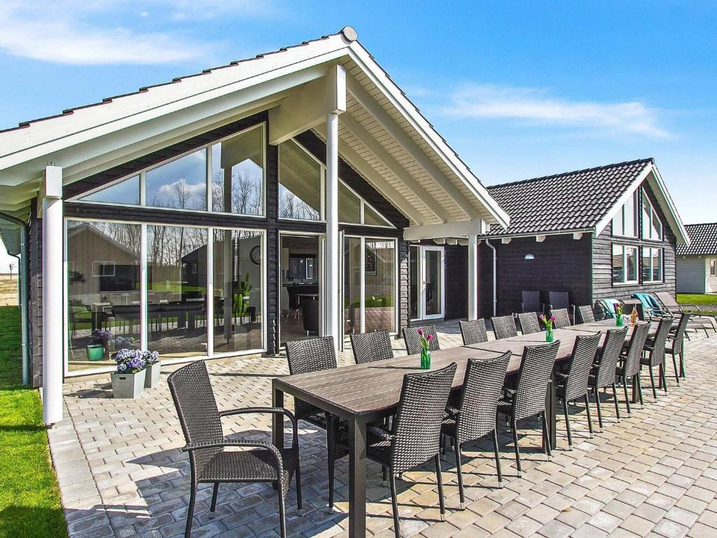 a patio with a wooden table and chairs at Holiday home Kappeln IV in Kappeln