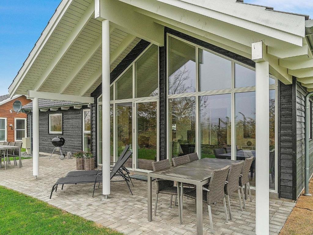 a screened in porch with a table and chairs at 10 person holiday home in Hasselberg in Kappeln