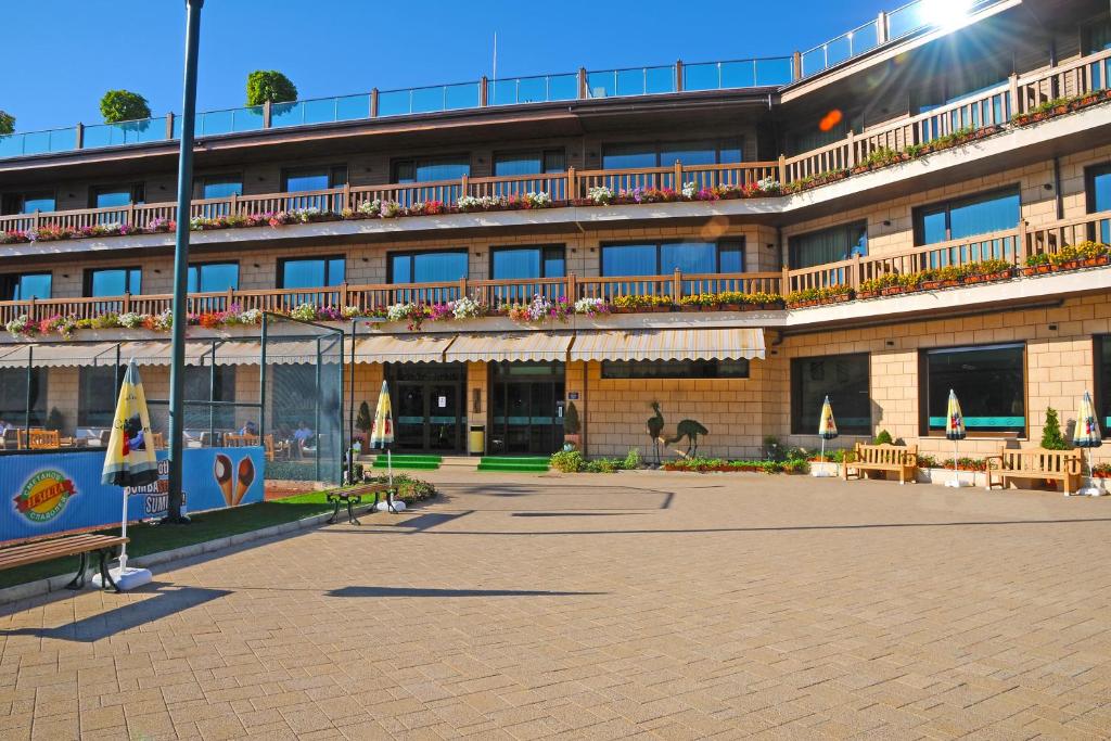 a large building with a patio in front of it at Park Hotel Izida in Dobrich