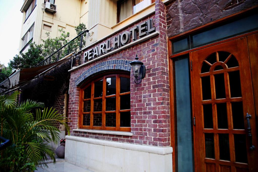 a brick building with a sign for a restaurant at Pearl Hotel, Maadi in Cairo