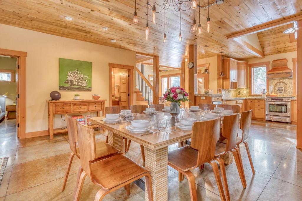 a dining room with a large wooden table and chairs at The Davenport - Meredith Lodging in Bend
