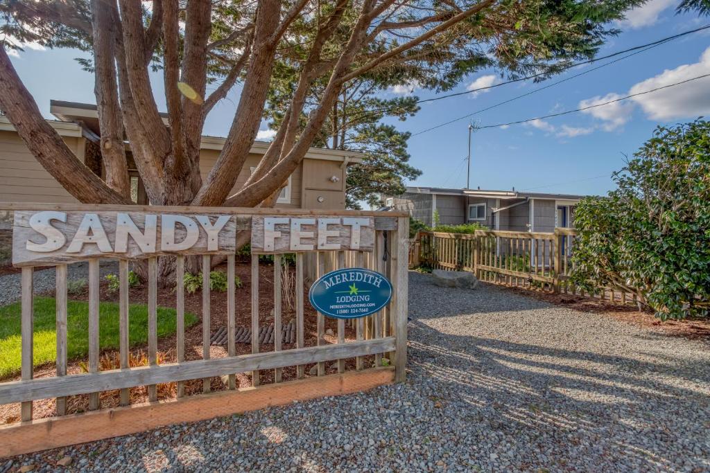 a gate with a sign that reads santa key at Sandy Feet in Nehalem
