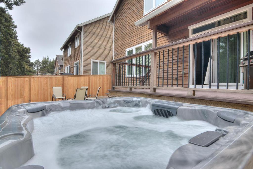 a hot tub in the backyard of a house at Kiwanda Breeze in Pacific City