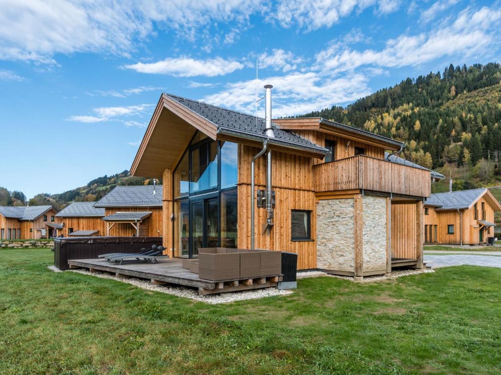 a log cabin with a porch and a lawn at Murau Chalet 8 in Laßrchberg