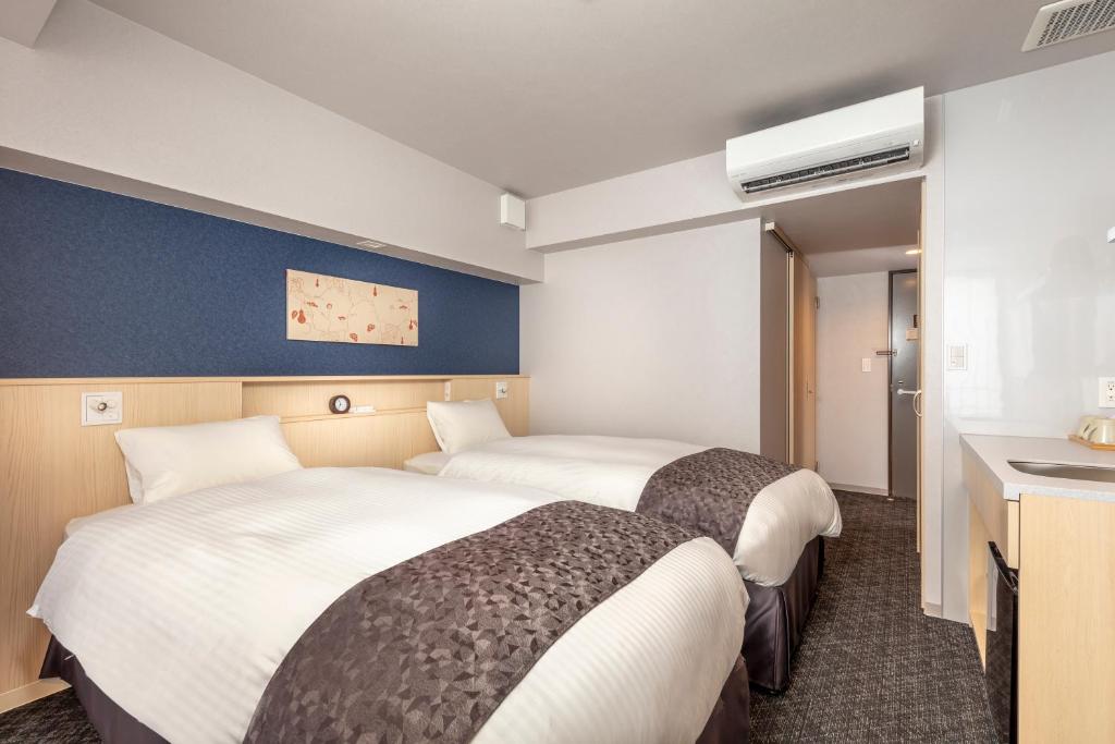 Postel nebo postele na pokoji v ubytování Hotel GOCO stay Kyoto Shijo Kawaramachi