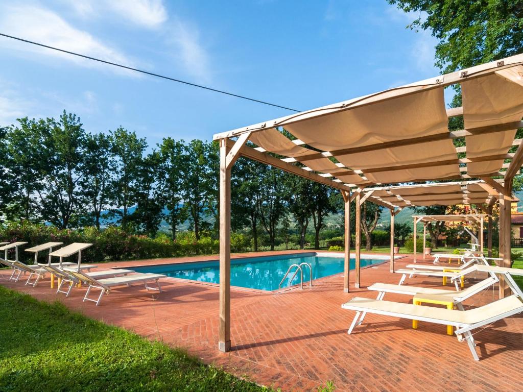 a pavilion with benches and a swimming pool at Scenic Apartment Near Pian di Sco with Private Terrace in Pian di Scò