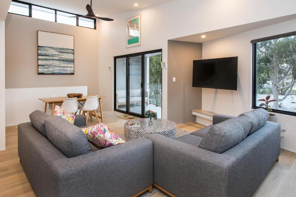 a living room with two couches and a tv at Central Heights - Main Street Views in Margaret River Town