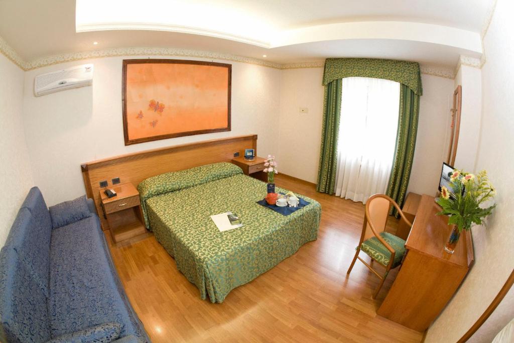 Postel nebo postele na pokoji v ubytování Hotel Verdi